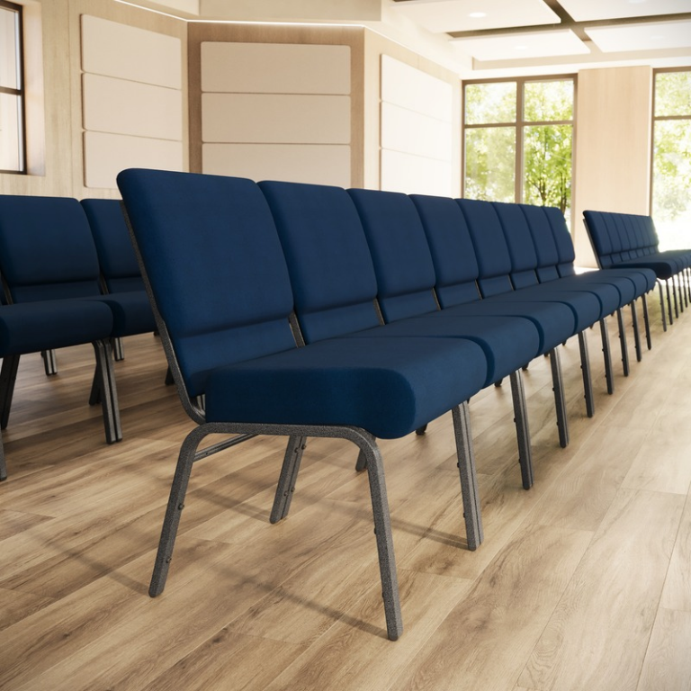 A row of modern conference or event seating chairs with dark blue upholstered seats and backs, supported by slim gray metal frames, arranged in a spacious room with light wood floors and paneled walls.